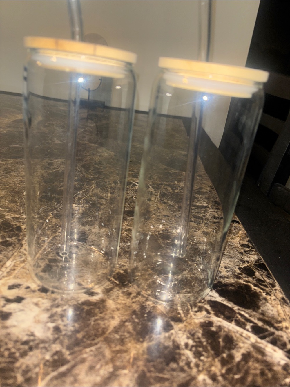 Set of glass cups with straws and lids